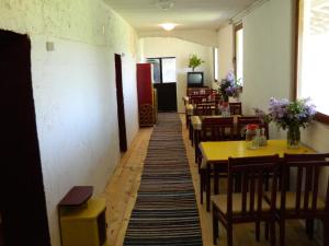 a hallway with tables and chairs in a restaurant at Twins V.V.T Hostel in Orešani