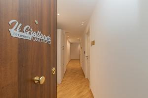 a corridor with a door with a sign on it at Suit Dante in Genoa