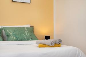 a bedroom with a bed with towels on it at Apartments ADELA in Polje