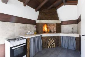 a kitchen with a stove and a fireplace at Haus Šimuni in Kršan