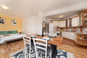 a kitchen and living room with a table and chairs at Apartments ADELA in Polje +13 photos