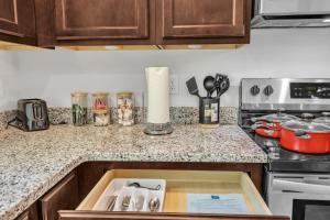 a kitchen counter with a sink and a stove at Upscale King 3BR Townhouse Mins to Cary & NC State in Raleigh +38 photos