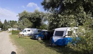 a group of vehicles parked in the grass near a road at Cottage 4 personnes in Mirepoix
