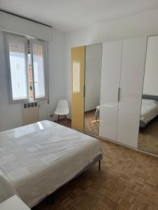 a bedroom with a bed and a large mirror at Via degli Dei house in Sasso Marconi +6 photos