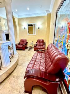 a waiting room with a leather couch and chairs at NEW BELLA HOTEL in Yerevan