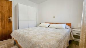 a white bedroom with a large bed with white pillows at Valentino in Novigrad Istria