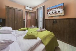 Postel nebo postele na pokoji v ubytování Park Hotel Bükfürdő