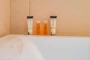 three bottles sitting on a shelf in a room at RIA Apartments in Mamaia Sat/Năvodari +51 photos