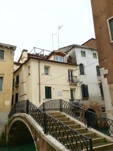 a bridge over a canal in front of a building at Ca dei Libri in Venice