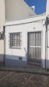 a white building with two windows and a door at Buenavista in Ayamonte