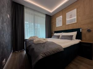 Postel nebo postele na pokoji v ubytování Bursztynowe Resort & SPA apartament 006
