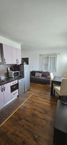 a kitchen and a living room with a couch at Apartmani Meri in Supetar