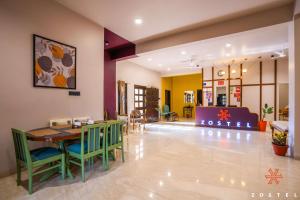 a dining room with a table and chairs at Zostel Indore in Indore