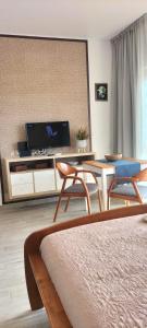 a living room with a table and a tv at Sol e Praia Alvor 1 in Alvor