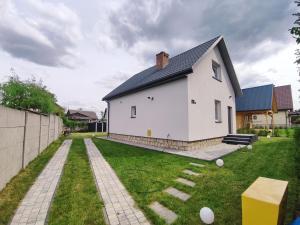 a large white house with a yard with a house at Sopocka Przystań - domek letniskowy in Ciotusza Stara
