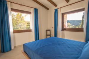 En eller flere senge i et værelse på Corbezzolo Villa Capelvenere