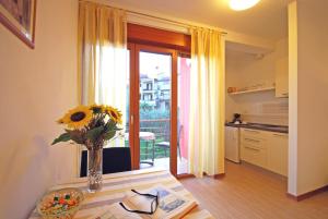 una cucina con tavolo e vaso con girasole di Apartments Sponza a Rovigno (Rovinj)