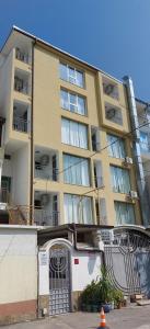 an apartment building with a gate in front of it at Guest house WEST in Sunny Beach