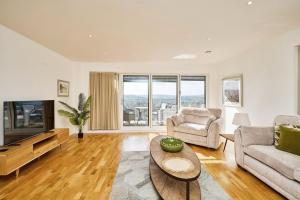 a living room with a couch and a tv at Castle View in Newport