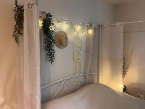 a bedroom with a bed with a white curtain and lights at "Gîte Ibiza" - AIRCO in Chamblet