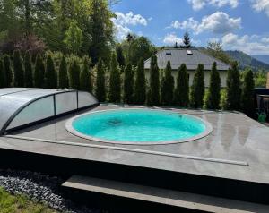a swimming pool in a yard with a patio at Vila Malenovice in Malenovice