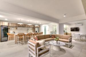 a living room and kitchen with a couch and a table at Olymp Luxury House - Ultra Luxury Beachfront Villa with Rooftop Lounge in Paphos