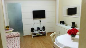 a living room with a tv on the wall at The Real COPACABANA APARTMENT in Rio de Janeiro