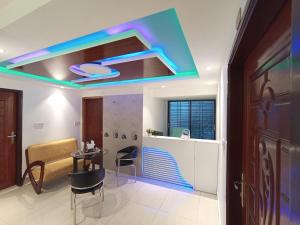 a living room with a blue light in the ceiling at Hotel ZN Palace 
