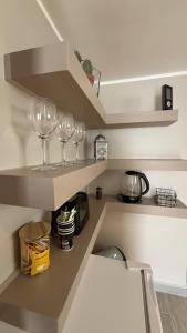 three wine glasses sitting on a shelf in a kitchen at Escapade cosy in La Celle-sous-Gouzon +7 photos