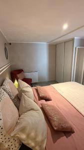 a bedroom with a large bed with pillows on it at Escapade cosy in La Celle-sous-Gouzon