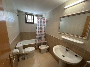 a bathroom with a toilet and a sink and a mirror at Sirocco Apartamento in Oropesa del Mar +20 photos