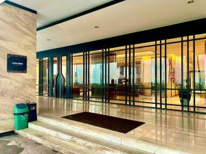 a building with a lobby with glass doors and a trash can at 2BR Pollux Habibie Meisterstadt Tower 1 Batam City in Batam Center +14 photos