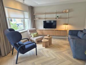 TV a/nebo společenská místnost v ubytování Hotel de Baak Seaside