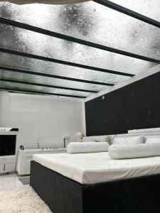 a bedroom with a bed and a ceiling at White Tiger Villa in Madgaon