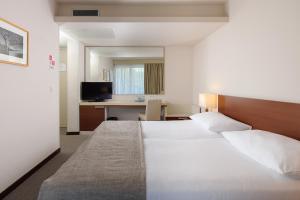 a hotel room with a bed and a desk at Hotel Albatros Plava Laguna in Poreč
