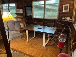 uma sala de jantar com mesa e cadeiras de madeira em Rustic cabin in the heart of the fields of Pitahaya em Cabo Rojo
