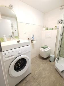 a bathroom with a washing machine and a sink at Ferienwohnung Sonnengarten in Meschede +8 photos