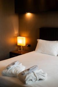 Voodi või voodid majutusasutuse Axolute Comfort Hotel Como Cantù toas