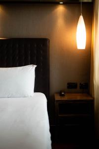 Voodi või voodid majutusasutuse Axolute Comfort Hotel Como Cantù toas