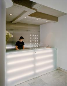 a man standing behind a counter in a room at Habita, Mexico City, a Member of Design Hotels in Mexico City