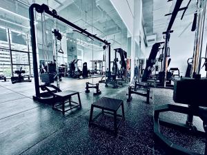 a gym with rows of equipment in a room at M Panda Tower Boutique Chengdu in Chengdu