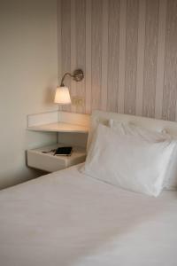 Voodi või voodid majutusasutuse Axolute Comfort Hotel Como Cantù toas