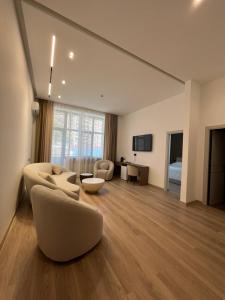 a large living room with a couch and a table at Prince Hotel Kapan in Kapan