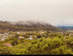 a small town on a hill with trees and clouds at The Flat in Sedgefield