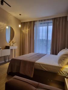 a bedroom with a large bed with a window at Bamboo Beach Tsikhisdziri LATTE in Ts'ikhisdziri +21 photos