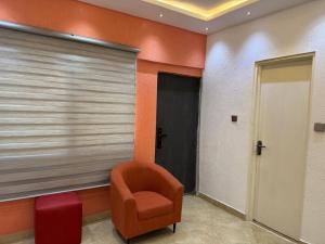 a waiting room with a chair and a window at AA home in Trofwi