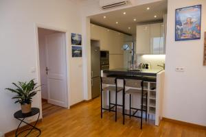 a kitchen with a counter and a island in a room at Amazing view - Monaco - Appartement Vue Mer in Cap d'Ail