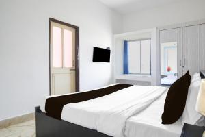 Voodi või voodid majutusasutuse Super Hotel O Dumduma Near DN Regalia Mall toas