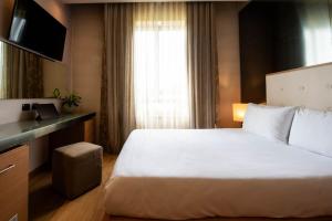 Voodi või voodid majutusasutuse Axolute Comfort Hotel Como Cantù toas