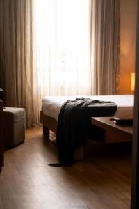 Voodi või voodid majutusasutuse Axolute Comfort Hotel Como Cantù toas